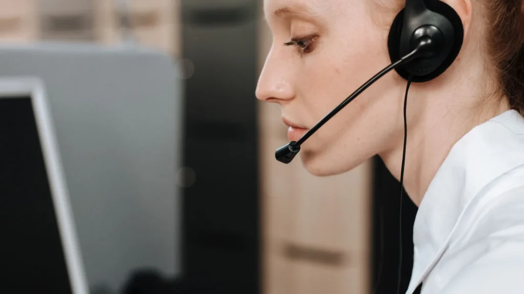 Customer service agent wearing a headset on a business call
