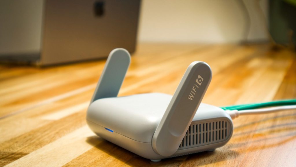 Wi-Fi router on a desk, where the SIP ALG setting lives